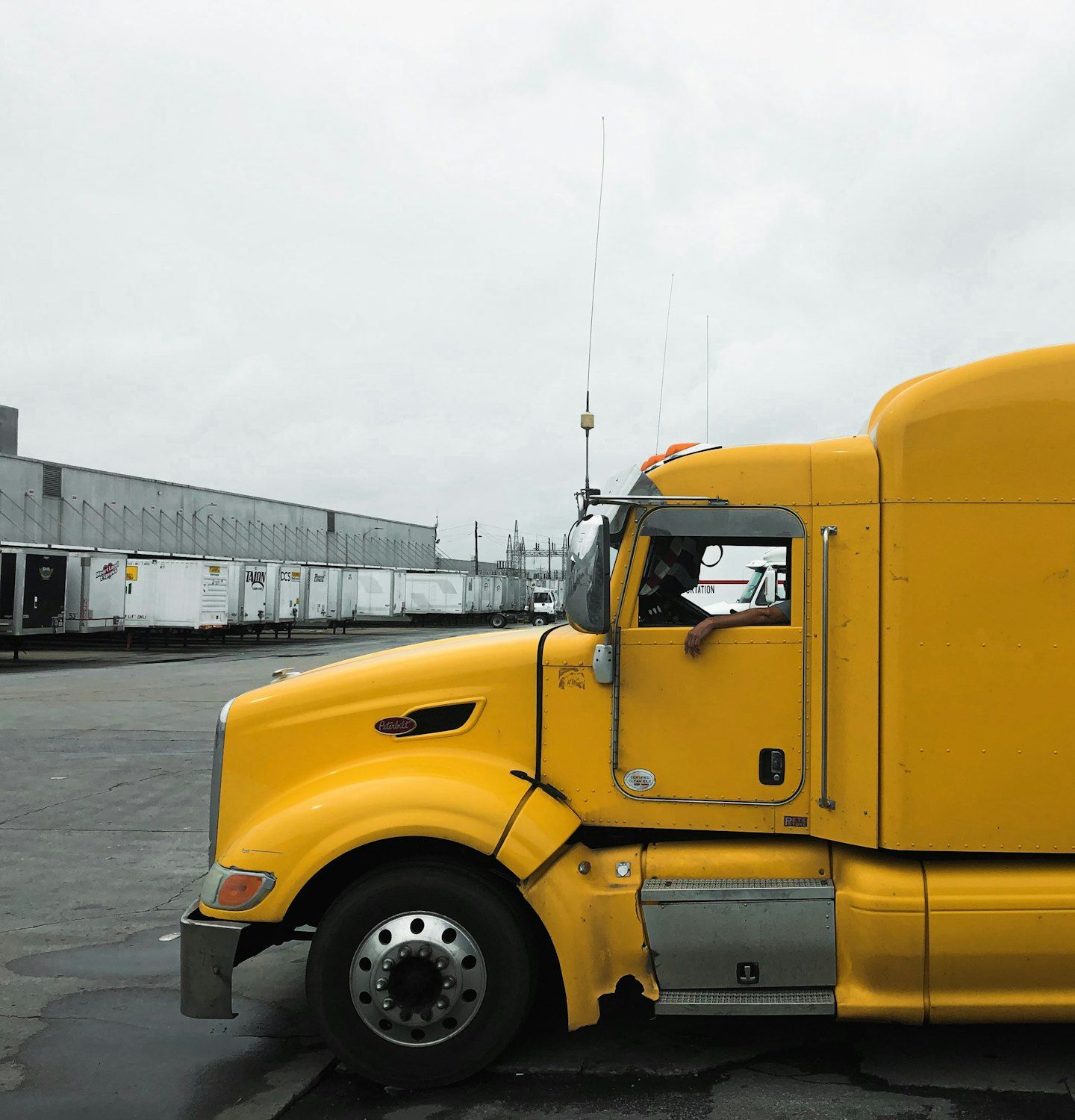 Yellow tractor with no trailer at a distribution center